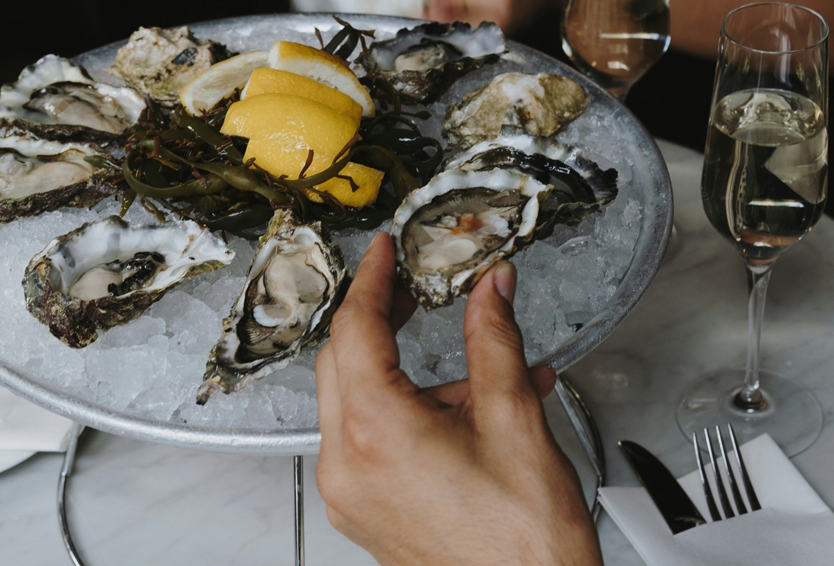 Diner eating French oysters with Champagne